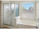 Bathroom featuring a soaking tub with a separate shower at 44010 W Wade Dr, Maricopa, AZ 85138