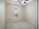 Well lit bedroom with carpeted floor and window overlooking native plants at 44010 W Wade Dr, Maricopa, AZ 85138