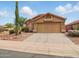 Charming single-Gathering home featuring a two-car garage and desert landscaping with a beautiful Saguaro cactus at 44010 W Wade Dr, Maricopa, AZ 85138