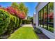 Serene backyard featuring green lawn, privacy hedges, and string lights at 4416 N 37Th Way, Phoenix, AZ 85018