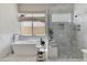Luxurious bathroom with a freestanding tub, a separate glass shower, and elegant marble tiling throughout at 4416 N 37Th Way, Phoenix, AZ 85018