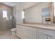 Elegant bathroom featuring dual sinks, a wide mirror, and a glass-enclosed shower at 4416 N 37Th Way, Phoenix, AZ 85018