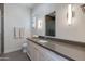 Sleek bathroom with a modern vanity, grey countertops, and a glass-enclosed shower at 4416 N 37Th Way, Phoenix, AZ 85018