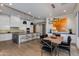 Modern kitchen features white cabinets, stainless steel appliances, an island with seating, and an adjacent dining area at 4416 N 37Th Way, Phoenix, AZ 85018