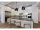 Modern kitchen features white cabinets, stainless steel appliances, stone countertops, an island with seating at 4416 N 37Th Way, Phoenix, AZ 85018