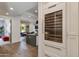Modern kitchen design with a sleek wine cooler, island, and open layout to the dining and living areas at 4416 N 37Th Way, Phoenix, AZ 85018