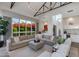 Bright living room with high ceilings features a large sectional sofa and an expansive window with lush landscaping at 4416 N 37Th Way, Phoenix, AZ 85018