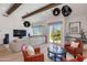 Bright, open-concept living room with wood beams, stylish furnishings, and access to outdoor area at 4416 N 37Th Way, Phoenix, AZ 85018