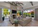 Bright living room features a concrete fireplace, hardwood floors, and large windows with views of the pool at 4416 N 37Th Way, Phoenix, AZ 85018