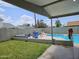 Relaxing backyard space with lush grass, a pristine pool, and comfortable seating for leisure at 4507 E Saint Catherine Ave, Phoenix, AZ 85042