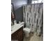 Cozy bathroom with vanity, toilet, and patterned shower curtain at 4507 E Saint Catherine Ave, Phoenix, AZ 85042