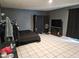 Spacious bedroom featuring tiled floors, a TV, and a ceiling fan for optimal comfort at 4507 E Saint Catherine Ave, Phoenix, AZ 85042