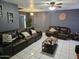 Comfortable living room with leather sofas, neutral decor, and tile flooring, perfect for relaxing and entertaining at 4507 E Saint Catherine Ave, Phoenix, AZ 85042