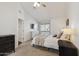This bedroom features a ceiling fan, television, and an ensuite bathroom at 510 N Alma School Rd # 252, Mesa, AZ 85201