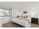 Bright bedroom features neutral tones, a large window, and two nightstands at 510 N Alma School Rd # 252, Mesa, AZ 85201