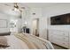 This bedroom features a ceiling fan, television, and ensuite bathroom at 510 N Alma School Rd # 252, Mesa, AZ 85201
