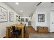 Charming dining area with a rustic wooden table, modern art, and an open layout to the kitchen at 510 N Alma School Rd # 252, Mesa, AZ 85201
