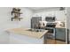 Modern kitchen with stainless steel appliances, butcher block countertop, and open shelving at 510 N Alma School Rd # 252, Mesa, AZ 85201