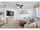 Cozy living room with a plush sectional sofa, a mounted TV, and stylish decor at 510 N Alma School Rd # 252, Mesa, AZ 85201