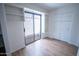 Bright bedroom with built-in shelves and closet, features a sliding glass door leading to a private patio at 5217 N 18Th Dr, Phoenix, AZ 85015
