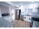 Modern kitchen features stainless steel appliances, granite countertops, white cabinetry, and a subway tile backsplash at 5217 N 18Th Dr, Phoenix, AZ 85015