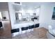 Bright modern kitchen flows into the dining area with breakfast bar seating, ideal for casual meals and entertaining at 5217 N 18Th Dr, Phoenix, AZ 85015