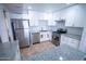 Modern kitchen with stainless steel appliances, granite countertops, white cabinets, and stylish tile backsplash at 5217 N 18Th Dr, Phoenix, AZ 85015