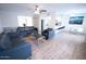 Open-concept living room boasts a modern ceiling fan, sleek furniture, and light wood flooring for a bright aesthetic at 5217 N 18Th Dr, Phoenix, AZ 85015