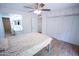 Bedroom featuring a ceiling fan, closet, wood floors, and ensuite bath at 5217 N 18Th Dr, Phoenix, AZ 85015