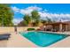 Inviting community pool area with lounge chairs, shaded seating, and well-maintained landscaping at 5217 N 18Th Dr, Phoenix, AZ 85015