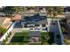 Aerial view of the backyard with a patio, artificial grass, putting green, pergola and fire pit at 5238 E Beck Ln, Scottsdale, AZ 85254