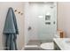 Stylish bathroom with a walk-in shower, white tile, and green vanity with marble countertop at 5238 E Beck Ln, Scottsdale, AZ 85254