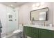 Stylish bathroom featuring a double sink vanity, modern lighting, and a glass-enclosed shower at 5238 E Beck Ln, Scottsdale, AZ 85254