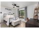 Well-lit bedroom with modern decor, large window, and desk area at 5238 E Beck Ln, Scottsdale, AZ 85254