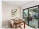 Bright dining area features a modern mirror, wood table, and sliding glass doors to the outdoor space at 5238 E Beck Ln, Scottsdale, AZ 85254
