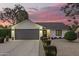 Charming home with a two-car garage, manicured landscaping, and inviting curb appeal at twilight at 5238 E Beck Ln, Scottsdale, AZ 85254