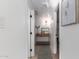 Bright hallway with console table, rug, artwork, and access to other rooms at 5238 E Beck Ln, Scottsdale, AZ 85254