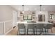 Spacious kitchen with a large center island, white cabinets, pendant lighting, and stainless steel appliances at 5238 E Beck Ln, Scottsdale, AZ 85254