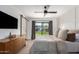 Inviting bedroom with natural light, modern ceiling fan, and barn door with access to bathroom at 5238 E Beck Ln, Scottsdale, AZ 85254