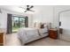 Serene primary bedroom with modern accents, a ceiling fan, and direct access to the backyard at 5238 E Beck Ln, Scottsdale, AZ 85254