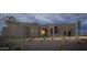 Twilight view of a modern home showcasing desert landscaping and a striking stone accent entry at 532 E Paint Your Wagon Trl, Phoenix, AZ 85085