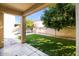Relaxing backyard featuring artificial turf and a covered patio, perfect for outdoor living at 5329 E Harmony Ave, Mesa, AZ 85206