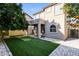 Beautiful home exterior boasts an artificial turf backyard, covered patio, and desert landscaping at 5329 E Harmony Ave, Mesa, AZ 85206