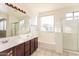 Bright bathroom with tub, shower and large vanity with white countertops at 5329 E Harmony Ave, Mesa, AZ 85206