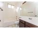 Bright bathroom features a shower-tub combo, large mirror, modern fixtures, and tile flooring at 5329 E Harmony Ave, Mesa, AZ 85206