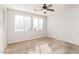 Cozy bedroom with neutral carpet, a ceiling fan, and bright windows at 5329 E Harmony Ave, Mesa, AZ 85206