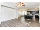 Bright, open-concept living room featuring a modern kitchen and hardwood floors at 5329 E Harmony Ave, Mesa, AZ 85206