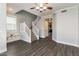 Open-concept living room featuring hardwood floors and a white staircase at 5329 E Harmony Ave, Mesa, AZ 85206