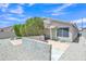 This backyard features mature landscaping, stone ground cover, and a tiled patio area at 6027 E Sayan Cir, Mesa, AZ 85215