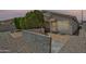 This backyard features mature landscaping, stone ground cover, and a tiled patio area at 6027 E Sayan Cir, Mesa, AZ 85215
